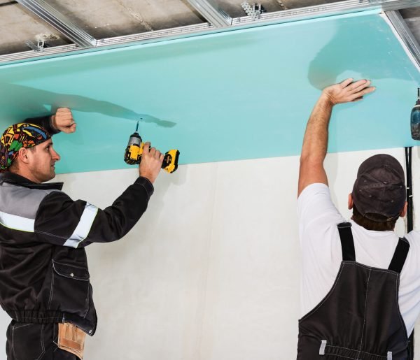 Plasterboard installers. Men assembling a drywall false ceiling.Simple and affordable renovation of premises